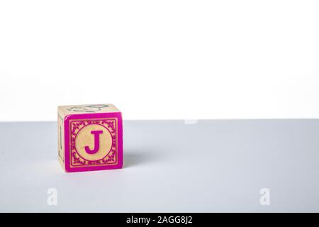 Childrens Wooden Alphabet Block Showing the Letter J Stock Photo