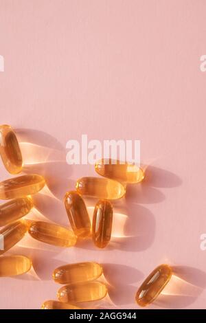 Pills or dietic supplements on the pink backgound Stock Photo