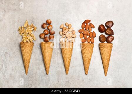 Ice cream cones with nuts on a marble table Stock Photo