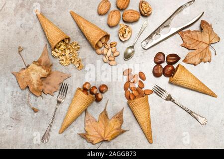 Ice cream cones with nuts on a marble table Stock Photo