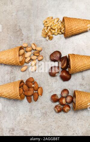 Ice cream cones with nuts on a marble table Stock Photo
