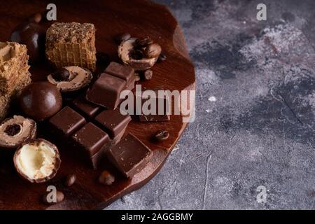 black and white chocolate, chocolates on a gray stone background Copy space Stock Photo