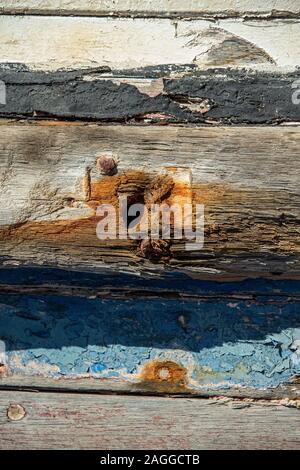 ust stained hole and old, peeling paint on old rotting hulk in the bay behind Luderitz Stock Photo