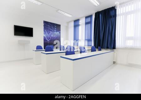 Economy school classroom without students or teachers with chairs and tables in campus. Education concept. Stock Photo