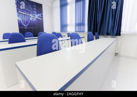 Economy school classroom without students or teachers with chairs and tables in campus. Education concept. Stock Photo