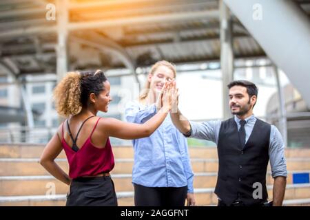 Business people working in office on desktop computer, Group of happy business people in smart casual wear looking at the laptop and gesturing. Achiev Stock Photo