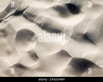 Full frame white desert sand texture shot from above. Stock Photo