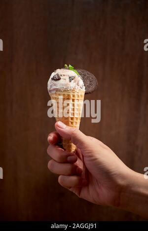 Sweet homemade ice cream with cookies in cone, selective focus Stock Photo