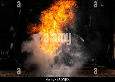 Flames caused by the explosion of the oil. Demonstration of water on oil fire. Stock Photo