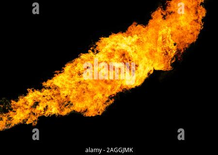 Flames caused by the explosion of the oil isolated on black background. Demonstration of water on oil fire. Stock Photo