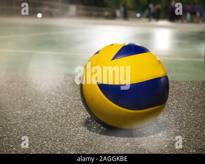 Low angle view of yellow-blue volleyball on the floor in court. Stock Photo