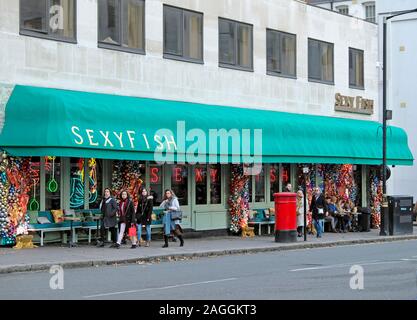 People walking in the street outside Sexyfish restaurant exterior in Berkeley Square London W1 England UK  KATHY DEWITT Stock Photo