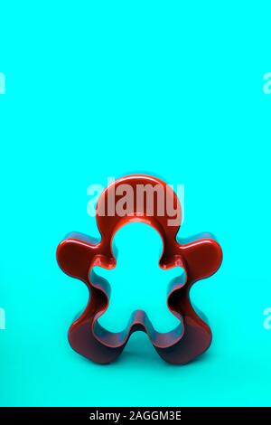 A form for cutting a gingerbread man standing on a blue emerald background Stock Photo