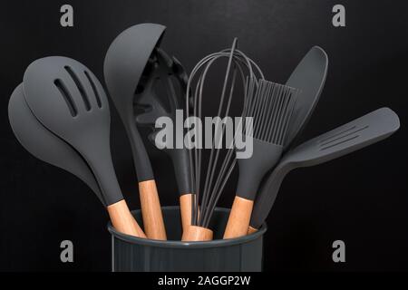 Kitchen utensils background with copyspace, home kitchen decor concept,  kitchen tools, rubber accessories in container. Restaurant, cooking,  culinary, kitchen theme. Silicone spatulas and brushes Stock Photo