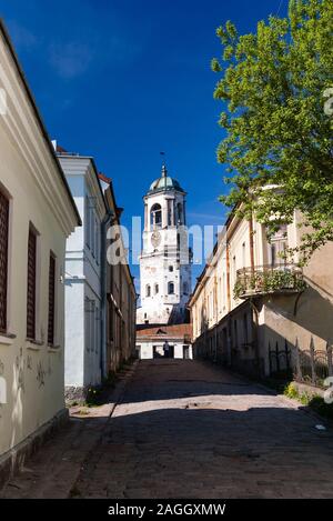 Old tower with clock on the end of street in Vyborg, Russia Stock Photo