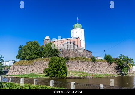 View on medieval Vyborg Castle from embankment at sunny day in Vyborg, Russia Stock Photo