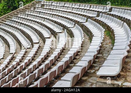 White plastic chairs in rows at outdoor stadium Stock Photo