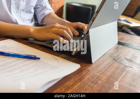 Side view of man typing on laptop Stock Photo