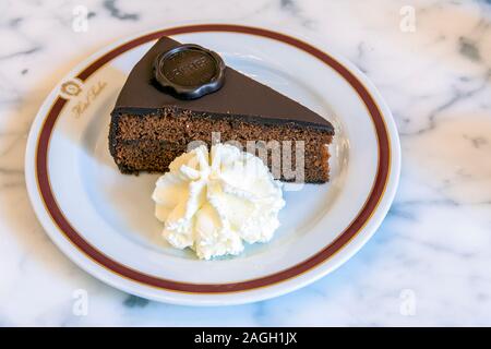 Sacher chocolate cake with cream served at Cafe Sacher, Vienna, Austria Stock Photo