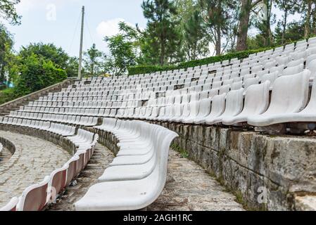 White plastic seat rows at outdoor stadium Stock Photo