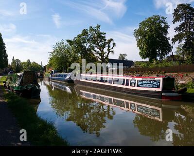 Canal boats moored on The Grand Union Canal, Stoke Bruerne, Northamptonshire, England, UK. Stock Photo