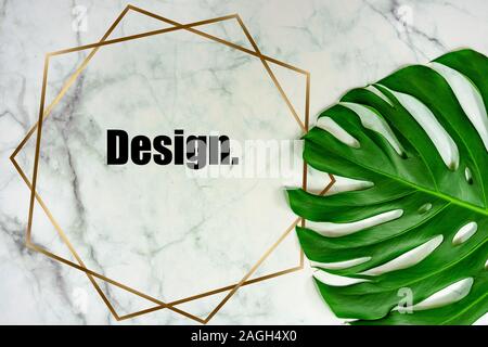 Marble background with monstera leaf and golden shape frame for text Stock Photo