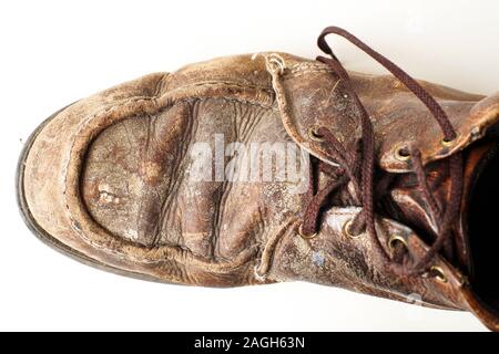 Photograph of man's dirty old leather boots on white background Stock Photo