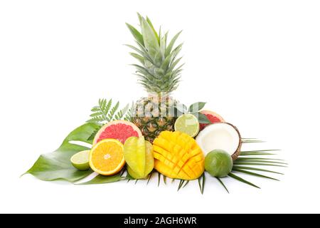 Fresh exotic fruits and palm leaves isolated on white background Stock Photo