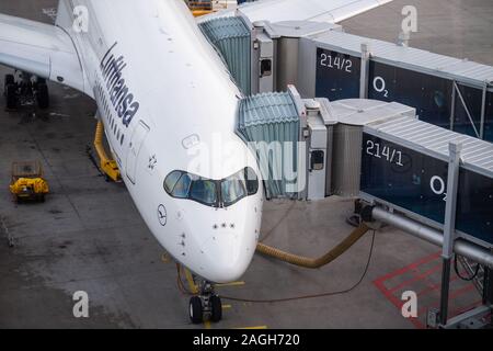 Munich, Germany. 19th Dec, 2019. A Lufthansa aircraft is docked at the gate at Munich Airport. In a press conference, Transport Minister Reichhart (CSU) announced the first test results of the newly installed safety system. Credit: Lino Mirgeler/dpa/Alamy Live News