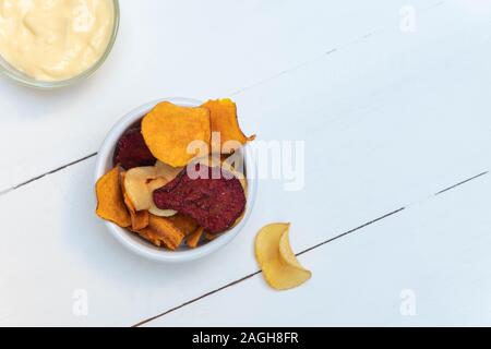 Vegan vegetable crisps made from parsnips, sweet potatoes, beetroot, carrots Stock Photo