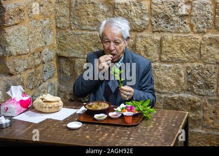 Local man eating foul, Souk Area, Tyre or Sour, Lebanon Stock Photo