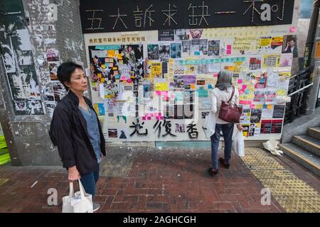 HongKong - November, 2019: People looking at Lennon Wall in Hongkong  during the 2019 HongKong protests Stock Photo