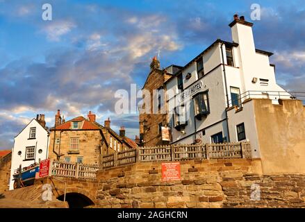 Bay Hotel pub & fishermans houses of the historic fishing village of Robin Hood's Bay, Near Whitby, North Yorkshire, England. Stock Photo