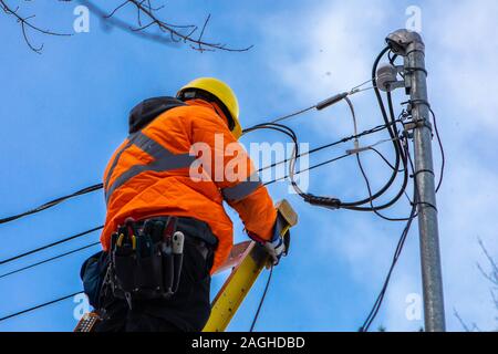 a workman working at height wearing an high visibility vest without any ...