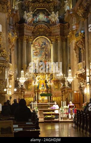 St Peters Church, Vienna, or Peterskirche, a Baroque Roman Catholic Church in Vienna - Church service and congregation in the interior; Vienna Austria Stock Photo