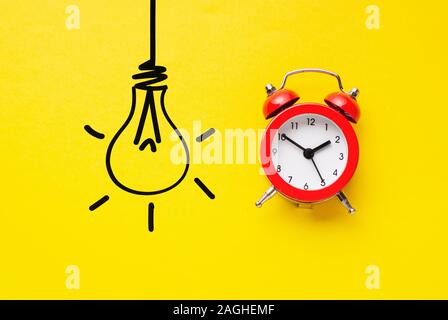 Alarm clock with hand drawn light bulb Stock Photo