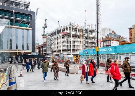 Construction work in Charing Cross Road at the junction of Tottenham Court Road and Oxford Street, London, UK Stock Photo