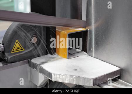 industrial metal machining cutting process of blank detail by mechanical electrical saw Stock Photo