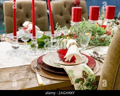 Elegant Christmas dinner table decoration, with dishes, glasses and candles Stock Photo