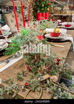 Elegant Christmas dinner table decoration, with dishes, glasses and candles Stock Photo