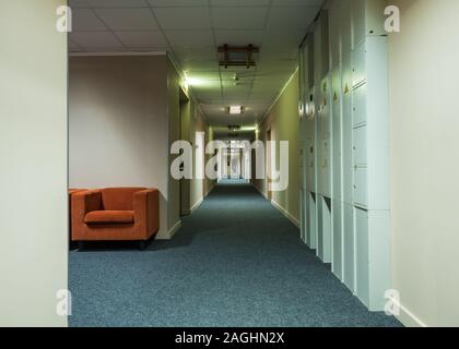 At the end of a long corridor, a girl pours water at hotel on Rosa Khutor Stock Photo