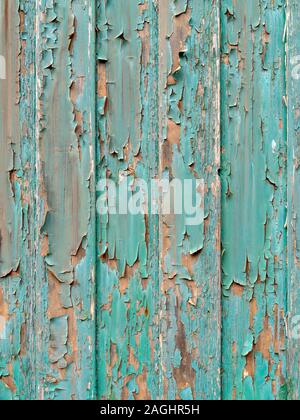Old peeling and flaking green paint on wooden slats Stock Photo