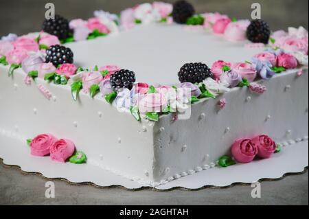 Sweet cake with strawberries on plate on grey wooden background Stock Photo