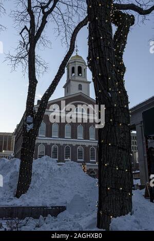 USA, Boston - January 2018 - snow banked up and decorated christmas trees in front of Faneuil Hall Marketplace