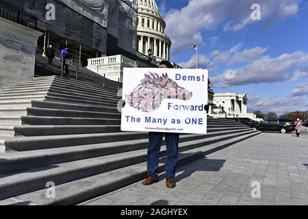 Washington, United States Of America. 18th Dec, 2019. Stephen Parlato of Boulder, Colorado holds a sign in front of the steps leading to the United States House Chamber at the US Capitol as the impeachment debate is going on inside in Washington, DC on Wednesday, December 18, 2019.Credit: Ron Sachs/CNP (RESTRICTION: NO New York or New Jersey Newspapers or newspapers within a 75 mile radius of New York City) | usage worldwide Credit: dpa/Alamy Live News Stock Photo