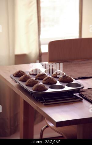 Chocolate chip muffins cooling on a rack in the dining room Stock Photo