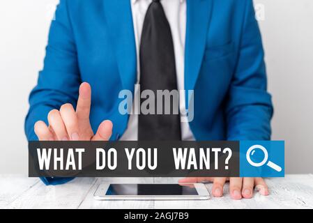 Writing note showing What Do You Want Question. Business concept for say or write in order to ask demonstrating about something Businessman with point Stock Photo