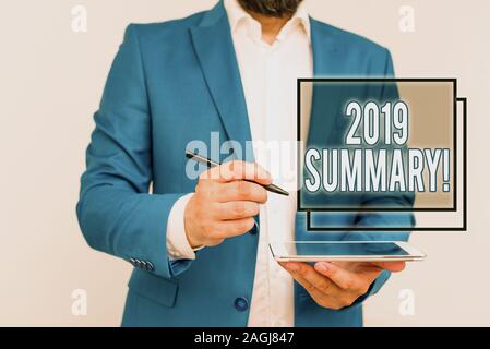 Handwriting text writing 2019 Summary. Conceptual photo summarizing past year events main actions or good shows Businessman with pointing finger in fr Stock Photo