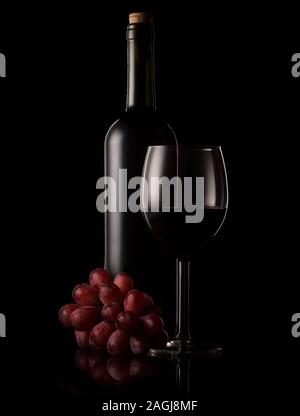 Red wine bottle and glass with black background and rim lighting. Stock Photo