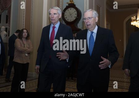 Washington, District of Columbia, USA. 19th Dec, 2019. United States Senator Rob Portman (Republican of Ohio) and United States Senate Majority Leader Mitch McConnell (Republican of Kentucky) walk to the Senate Floor on Capitol Hill in Washington, DC, U.S., on Thursday, December 19, 2019. Last night, the United States House of Representatives approved two articles of impeachment against United States President Donald J. Trump, but there is no clear timeline for when those articles may come before the Senate. Credit: Stefani Reynolds/CNP/ZUMA Wire/Alamy Live News Stock Photo